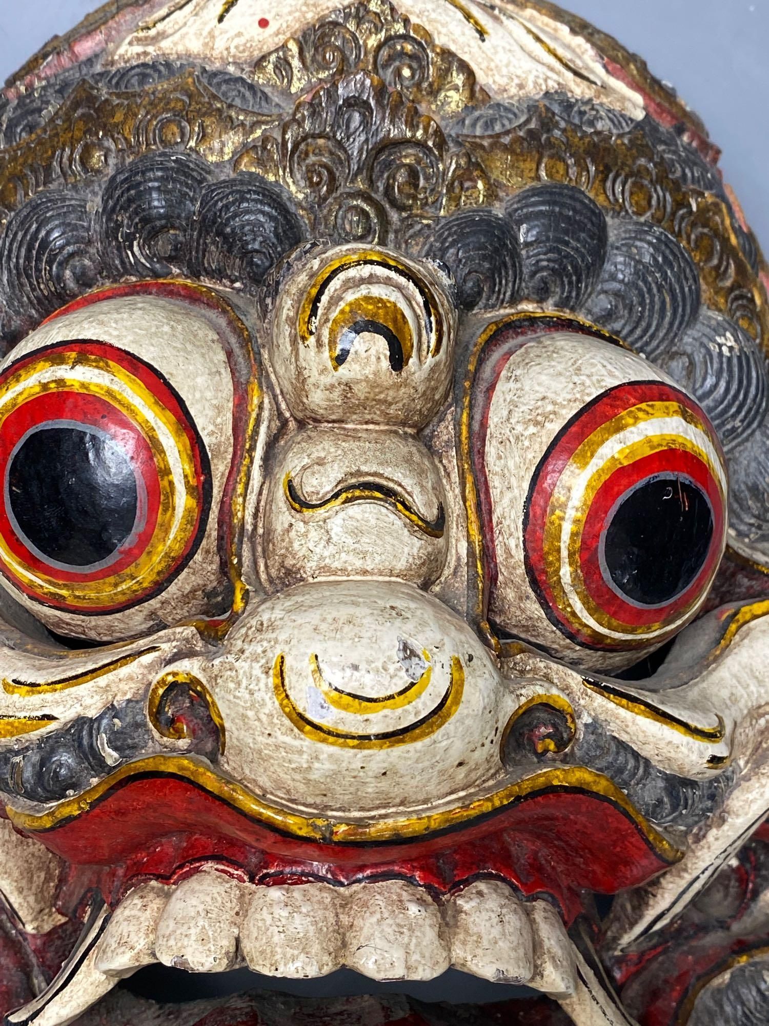 A Balinese carved and painted wood dragon mask, 28cm